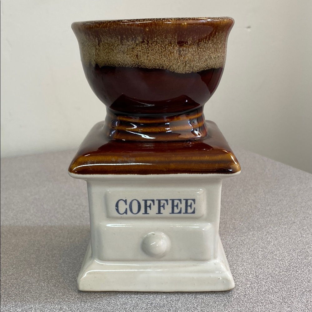Vintage brown and cream mill grinder look for utensils or a plant.